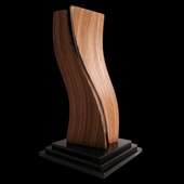 Laminated wood sculpture on a multi-tiered base.