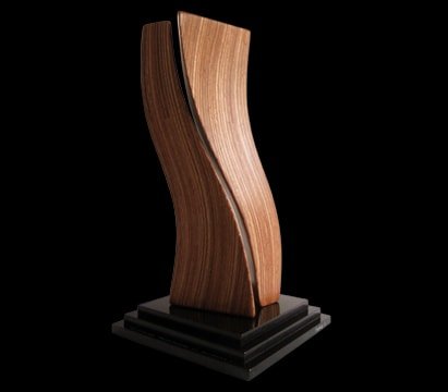 Laminated wood sculpture on a multi-tiered base.