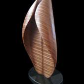 Laminated wood sculpture that curves in on itself.