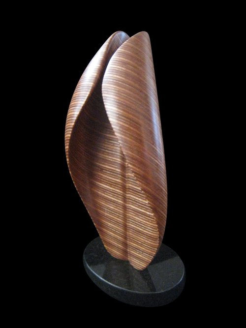 Laminated wood sculpture that curves in on itself.