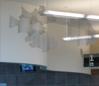 Expanded aluminum mesh fish are curved to match the curved walls.