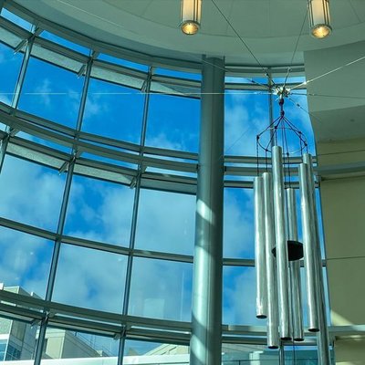 The chimes hang in a rotunda surrounded by windows.