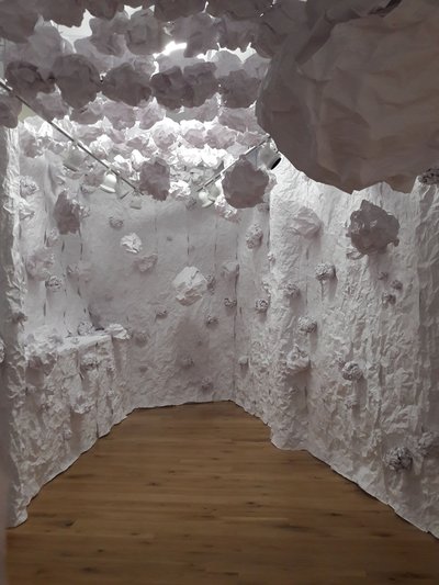 The paper tunnel has sculpted, rough walls and paper "boulders" that hang down.