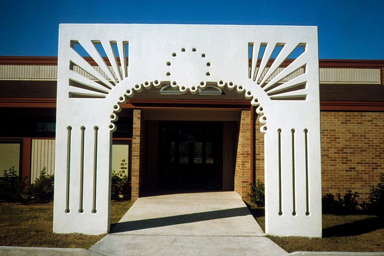 The precast concrete archway sculpture stands at the entrance to the Longbranch Community Center.