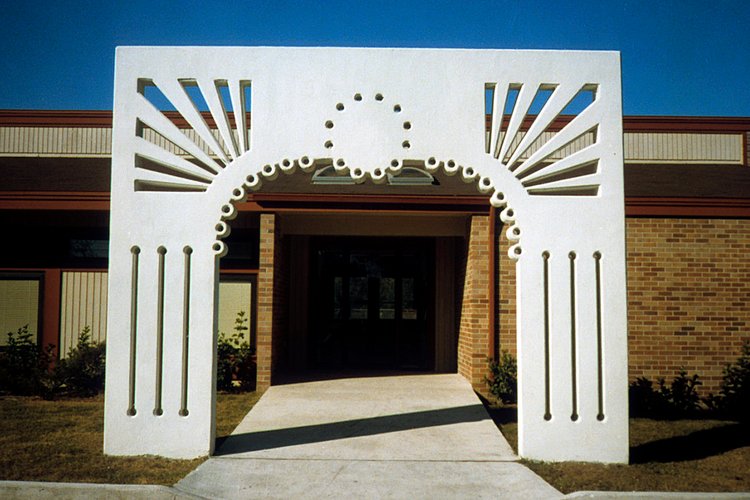 The precast concrete archway sculpture stands at the entrance to the Longbranch Community Center.