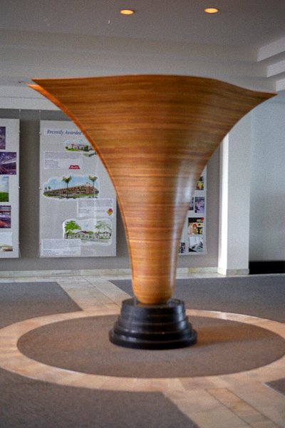 The large laminated wood sculpture stands in the center of the entrance to the Haskell Company building.