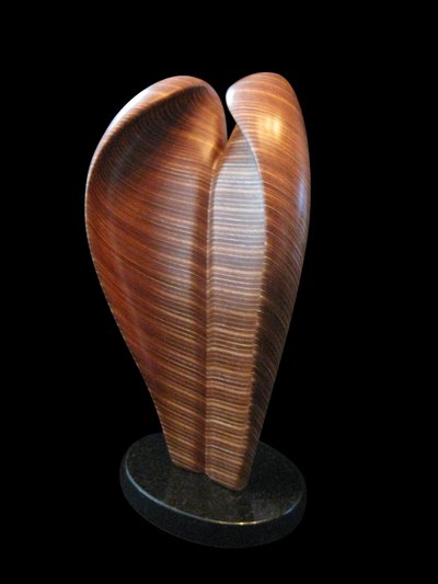 Laminated wood sculpture that curves in on itself.