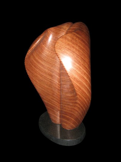 Laminated wood sculpture that curves in on itself.