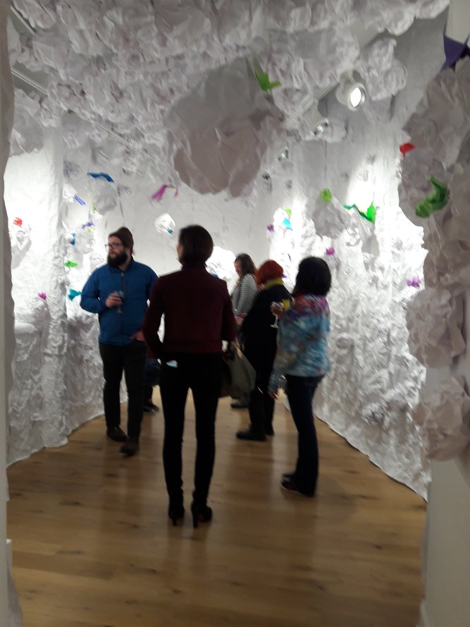 People in the tunnel of reclaimed end paper rolls.