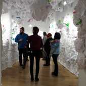 People in the tunnel of reclaimed end paper rolls.