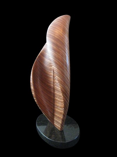 Laminated wood sculpture that curves in on itself from the top right and the bottom left.