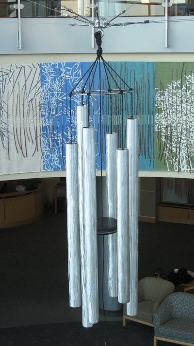 The chimes hang in a rotunda with other art that compliments the chimes' textured metal.