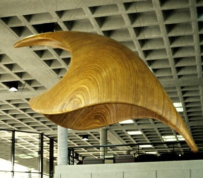 Laminated wood sculpture that is arched down to imply descent.