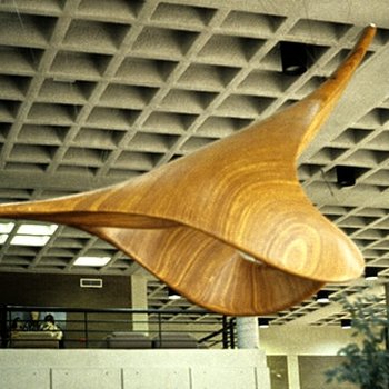 Laminated wood sculpture that is arched up to imply ascent.