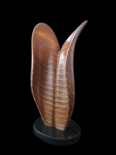Laminated wood sculpture that curves open at the top.
